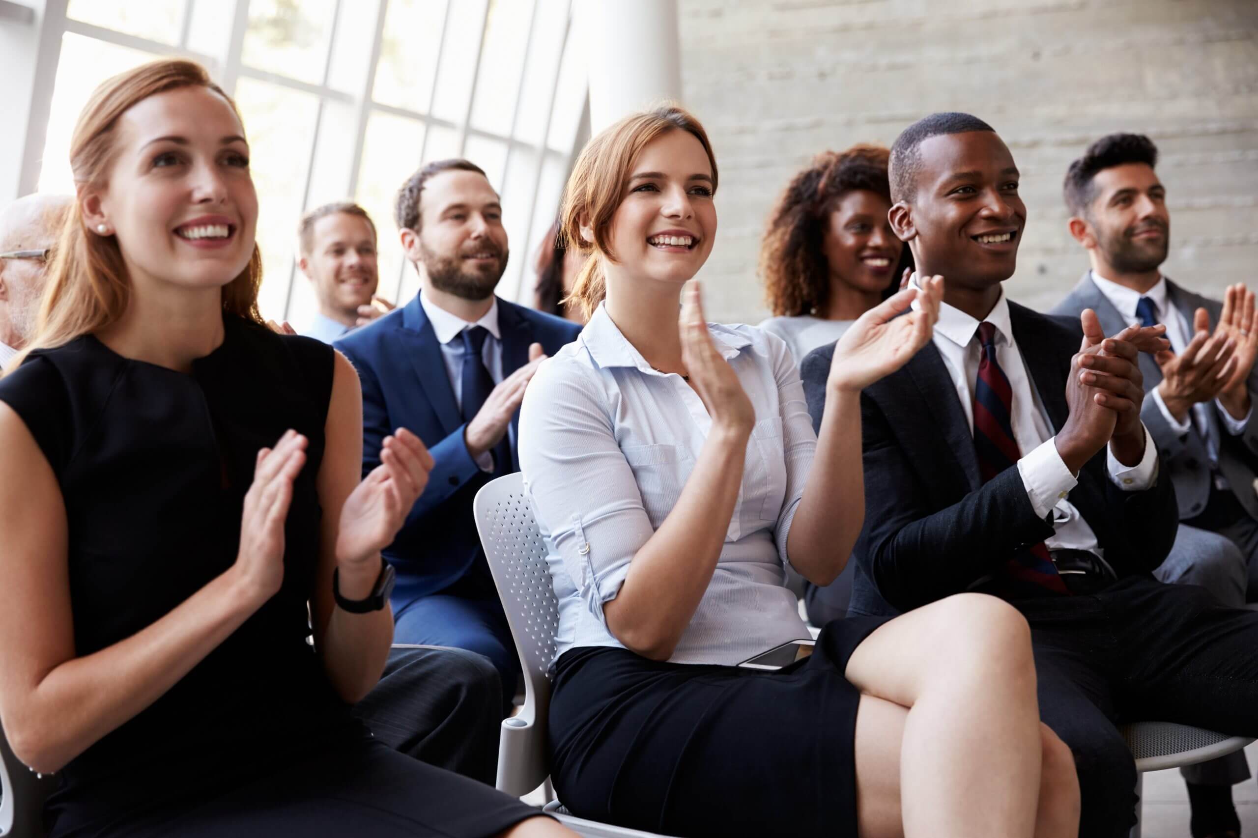 Audience Applauding Speaker At Business Conference